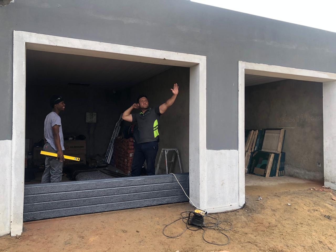Garage-door installation in progress with installers