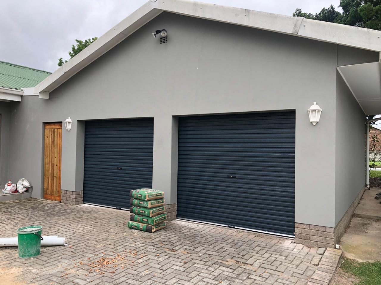 Two single charcoal roll-up garage doors